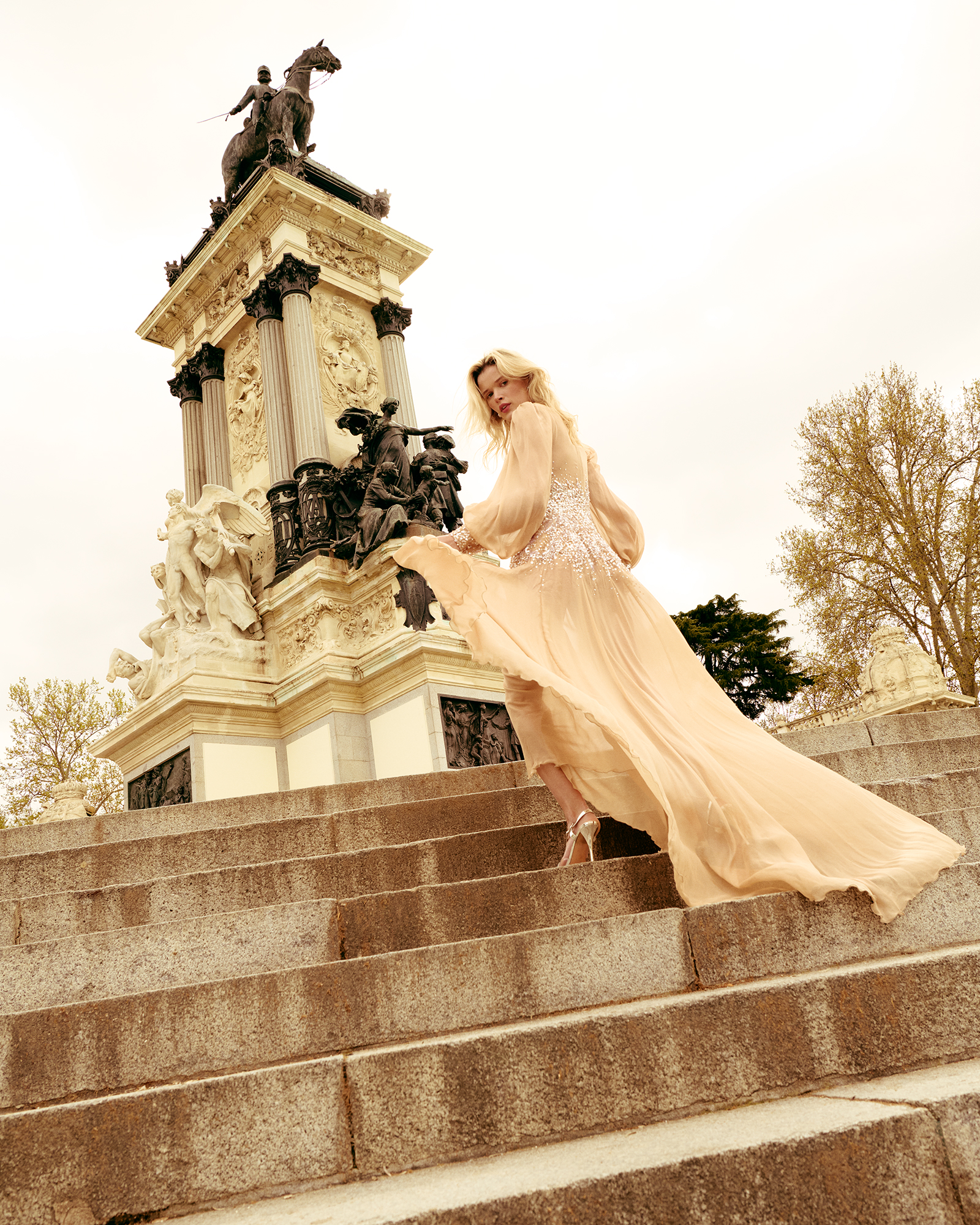 Model posing in the stairs showing Magrit shows for L'Officiel Baltic. Photography by Roberto Maroto